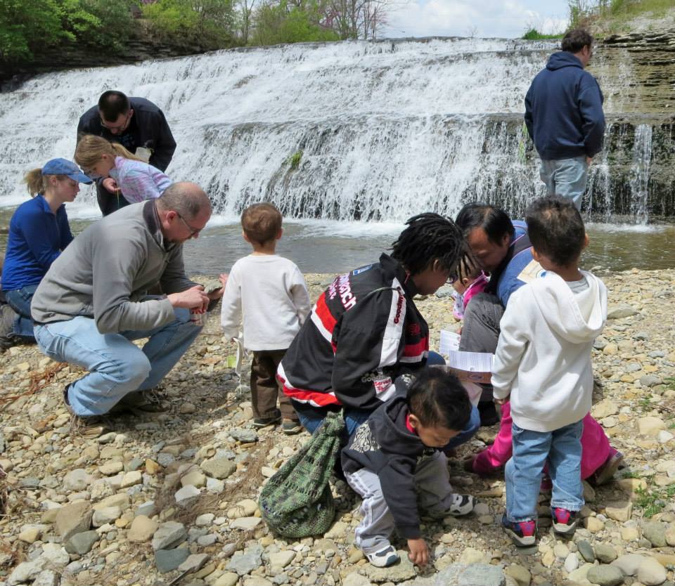 Children and their parents discovering fossils in Richmond, Indiana at a Whitewater Valley Fossil Hunt