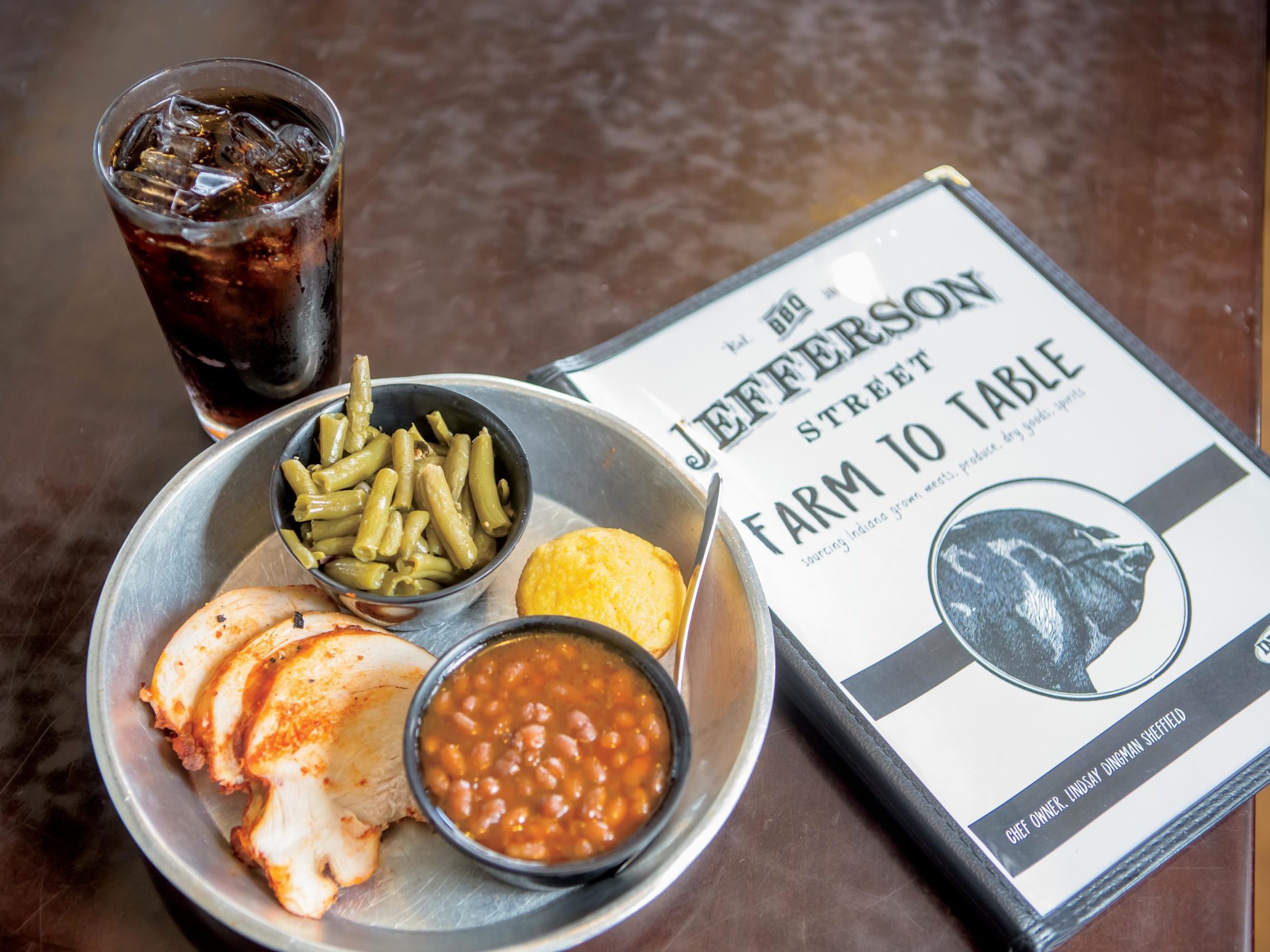 A quarter rack of ribs with green beans, baked beans and corn bread at Jefferson Street BBQ in Converse, Indiana