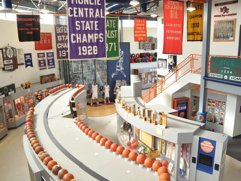 Memorabilia including jerseys, trophies, pendants, and plaques on display at the Indiana Basketball Hall of Fame