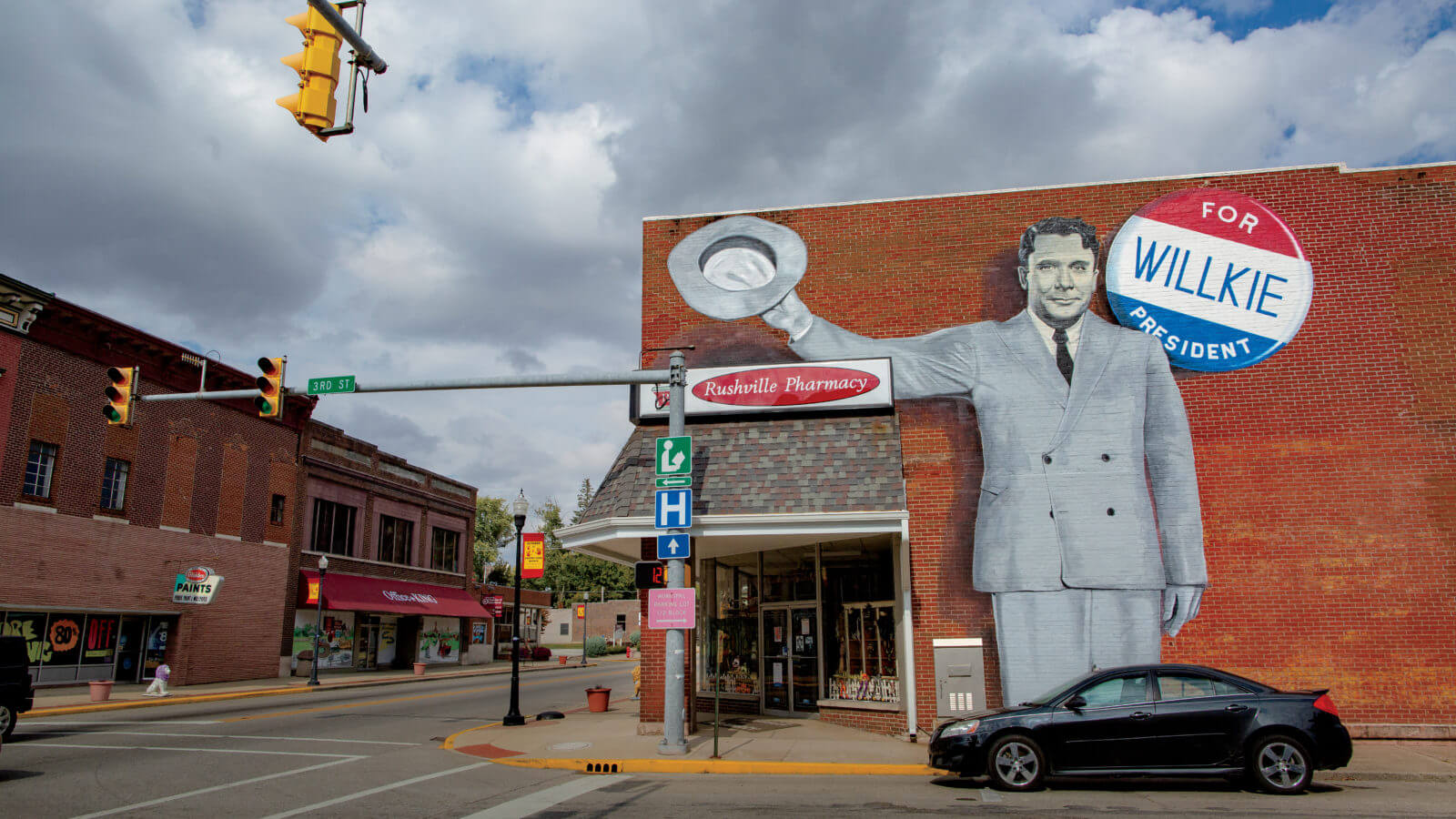 Mural of Wendell Willkie on the side of a brick pharmacy in Rushville, Indiana