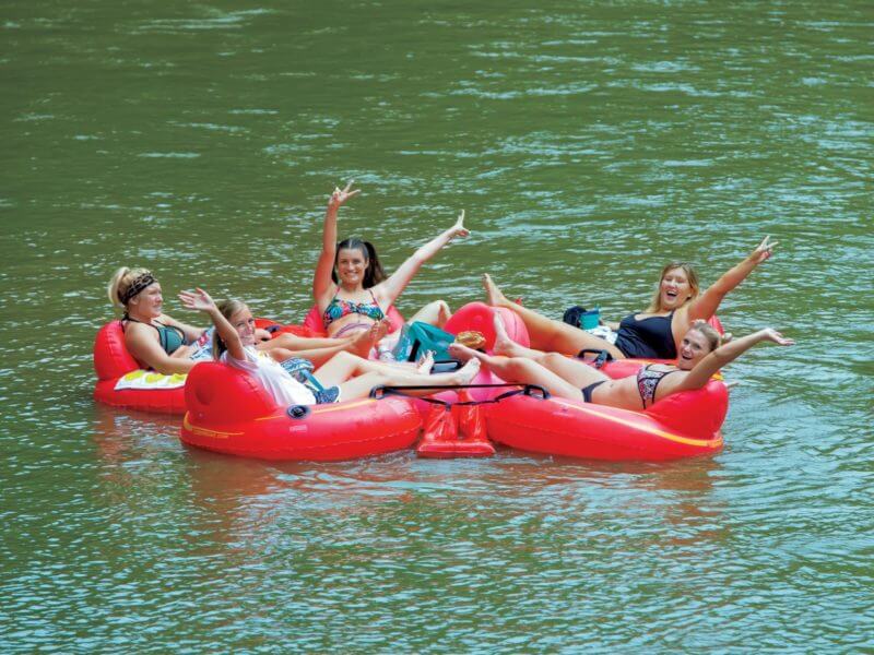Women tube down the White River between Yorktown and Daleville, Indiana